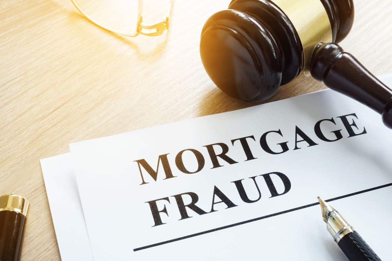 Mortgage fraud evidences and gavel on a desk.